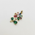 Gold pendant with colorful gemstones on a white background