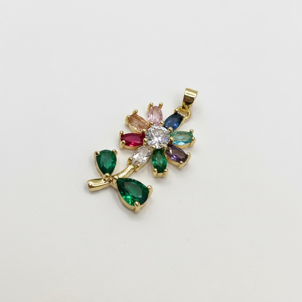 Gold pendant with colorful gemstones on a white background