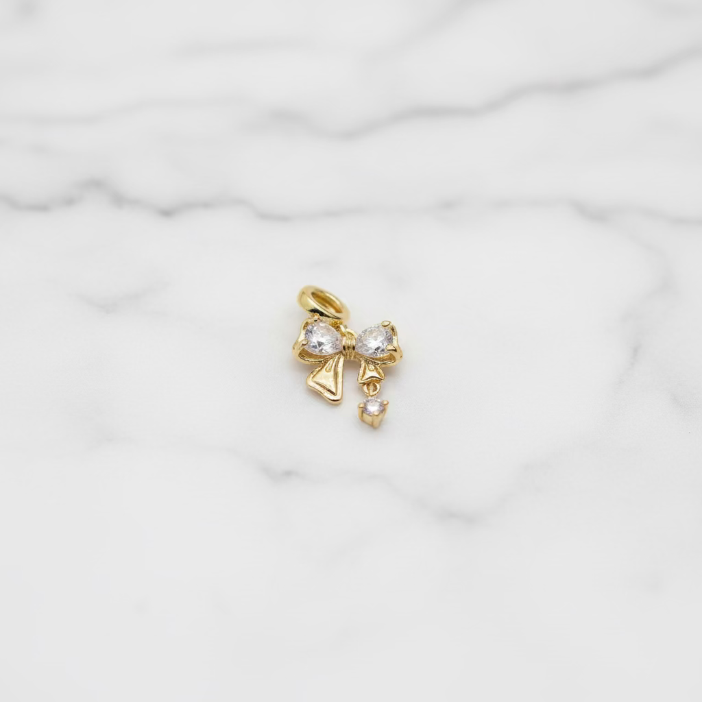14K BOW DESIGN WITH CLEAR GEMSTONES PENDANT