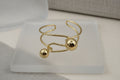 14K OPEN CUFF BRACELET WITH TWO SPHERES CH-24560001