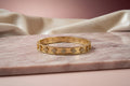 14K BANGLE BRACELET WITH DETAILED DESIGN