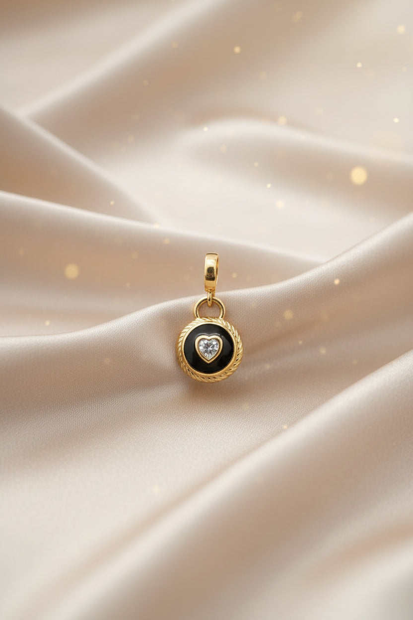 14K BLACK CIRCULAR PANDORA CHARM PENDANT WITH A CLEAR HEART-SHAPED STONE